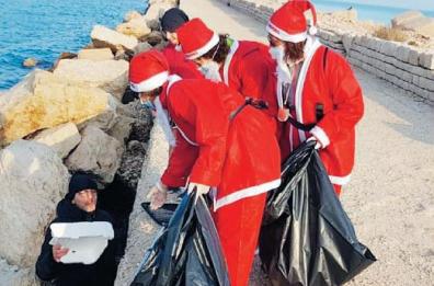 Barletta, i Babbo Natale puliscono il molo di Levante
