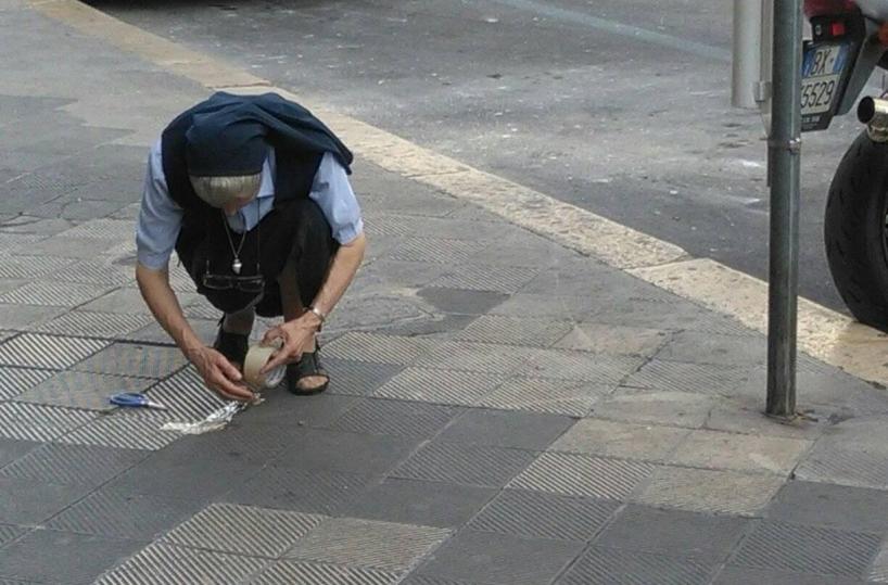 Bari, la suora ripara con lo scotch le mattonelle rotte del marciapiede